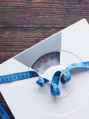 a scale with a tape measure lying across it