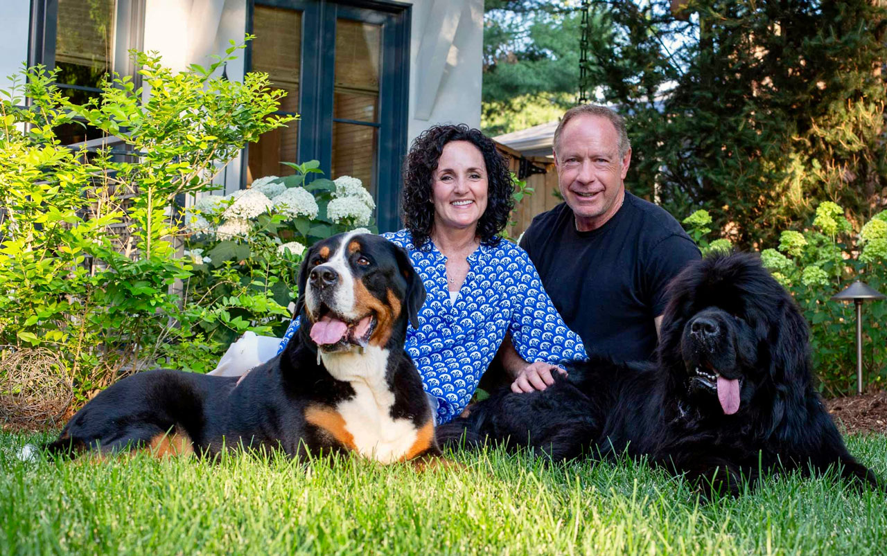 Julie James with her husband, greater swiss mountain dog and newfoundland dog