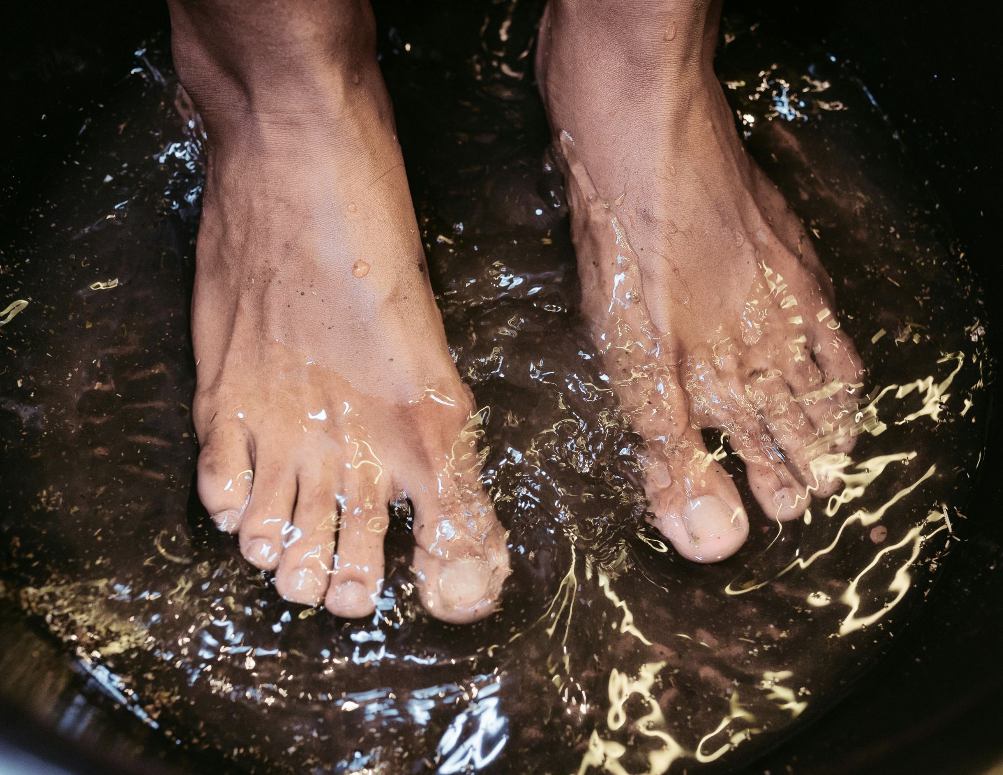 a woman standing in some cool shallow water at the edge of a lake